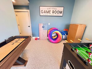 A game room with a pool table, foosball table, and a sign reading 'Dewey Beach Game Room No cheating - No fighting - No whining.' - New Spacious 5-bedroom condo in the heart of fabulous Dewey Beach (Dewey Beach)