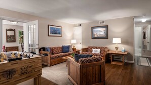 A cozy living room with a foosball table, two sofas, and a coffee table. - Right Mtn Attitude · Arcade, Hot Tub & Fire Pit (Berkeley Springs)
