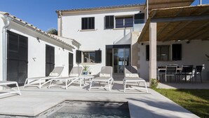 A modern house with a swimming pool, outdoor seating, and a patio area. - Beachfront Villa With Pool, Puerto Pollenca (Pollença)