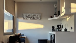 A modern kitchen with a dining area, a trash bin, and a coffee machine. - Bevimar Moonlight Suite with Private Pool and Non Heated Jacuzzi (Finikia)