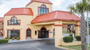 A hotel with a red roof, a clear entrance, and a Days Inn sign. - Days Inn by Wyndham Orangeburg (Orangeburg)