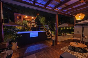 A wooden deck with a hot tub, outdoor seating, and a staircase leading to a house. - Tranquilandia Estate-Private Villas Retreat (Río Grande)