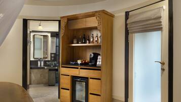 A kitchen with wooden cabinetry, a built-in coffee maker, and a refrigerator.