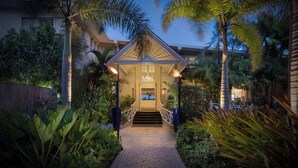 A well-lit entrance with a covered staircase leading to a building, surrounded by lush tropical plants. - Sea Breeze Beach House All Inclusive by Ocean Htls (CHRIST CHURCH)