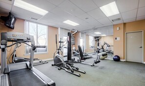 A gym with various exercise equipment, including treadmills, stationary bikes, and weight machines. - Stylish 1BR+Den Retreat in Markham (Markham)
