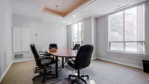 A conference room with a round table, four chairs, and large windows. - Stylish 1BR+Den Retreat in Markham (Markham)