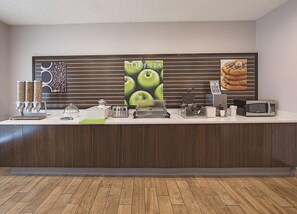 A hotel reception area with a coffee station, a microwave, and a waffle maker. - La Quinta Inn Suites Central Point Medford (Central Point)