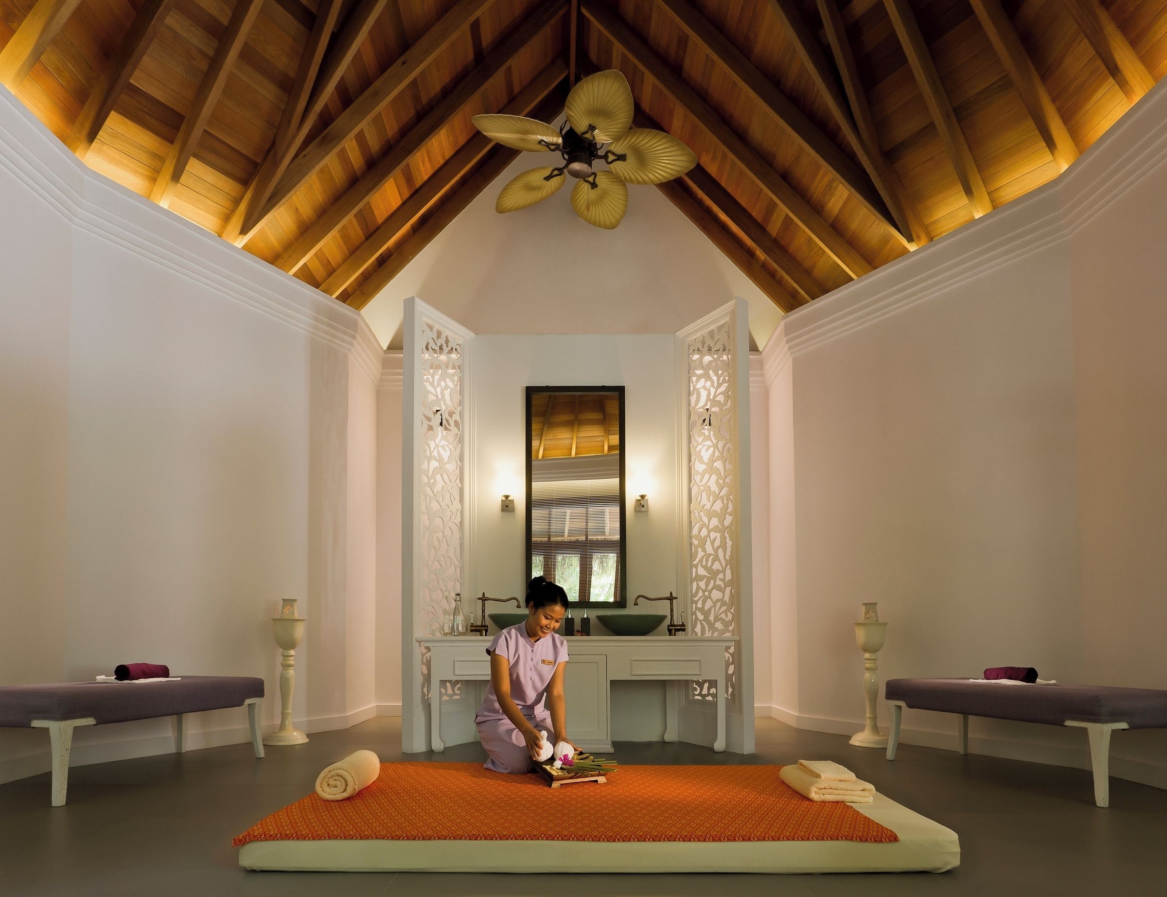 A room with a wooden ceiling, a ceiling fan, a massage table, a massage table with a towel, a massage table with a towel, a massage table with a towel, a massage table with a towel, a massage table with a towel, a massage table with a towel, a massage table with a towel, a massage table with a towel, a massage table with a towel, a massage table with a towel, a massage table with a towel, a massage table with a towel, a massage table with a towel, a massage table with a towel, a massage table with a towel, a massage table with a towel, a massage table with a towel, a massage table with a towel, a massage table with a towel, a massage table with a towel, a massage table with a towel, a massage table with a towel, a massage table with a towel, a massage table with a towel, a massage table with a towel, a massage table with a towel,
