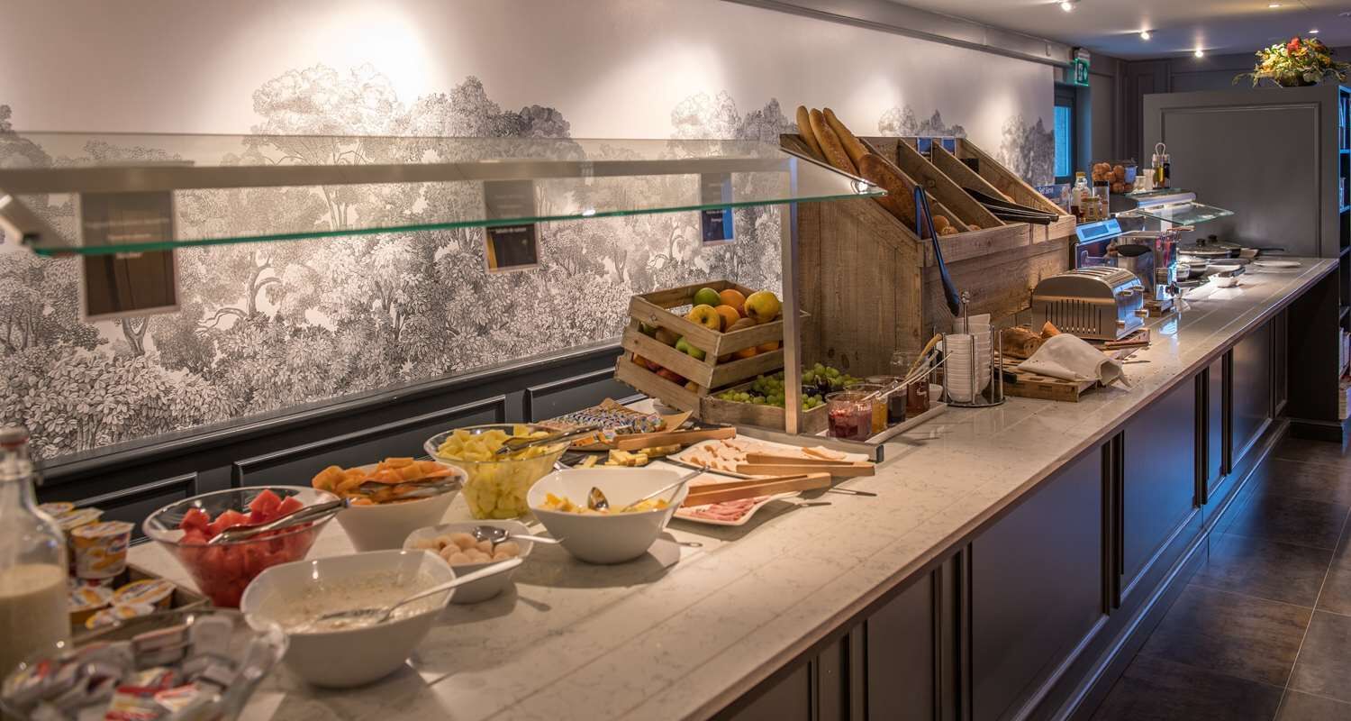 A buffet setup with various food items and a glass display case.