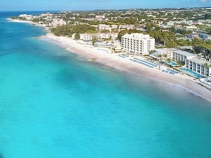 A coastal resort with a beachfront, a pool area, and a hotel building. - Sea Breeze Beach House (Oistins)