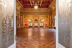 A spacious hall with a wooden floor and ornate wall designs. - Schweizerhof (Lucerne)