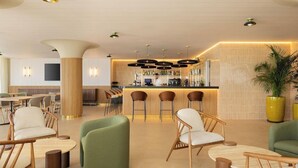 A modern bar area with a counter, bar stools, and ambient lighting. - Hotel Playa Mallorca (Palma de Mallorca)