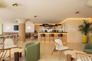 A modern bar area with a counter, bar stools, and ambient lighting. - Hotel Playa Mallorca (Palma de Mallorca)