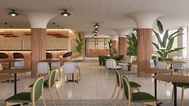 A spacious lobby with multiple seating areas, including tables and chairs, and a reception desk. - Hotel Playa Mallorca (Palma de Mallorca)