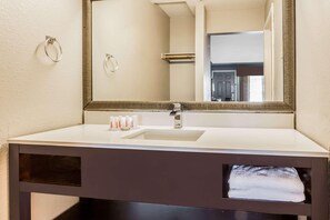 A bathroom with a white sink, a large mirror, and a towel rack. - Super 8 by Wyndham Mountain View (Mountain View)