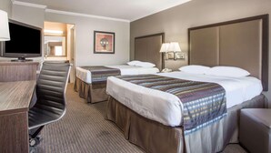 A hotel room with a desk, two beds, a chair, a television, and a framed picture on the wall. - Super 8 by Wyndham Mountain View (Mountain View)