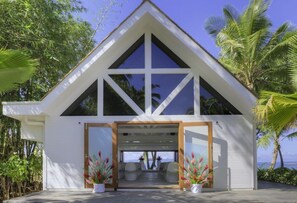 A modern house with a triangular roof, large windows, and a covered entrance. - The Pearl Resort Spa & Golf Course (Pacific Harbour)