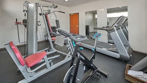 A gym with various exercise equipment including a bench press, a leg press, and a treadmill. - Senia Reforma (Mexico City)