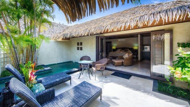A private pool area with lounge chairs, a table, and a thatched-roof structure. - Te Manava Luxury Villas Spa (Rarotonga)