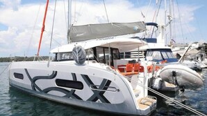 A sailboat docked at a marina with a covered deck area and a cabin. - Excess 11 - DIOSCURI (Pula)