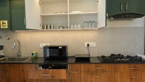 A kitchen with a microwave, stove, and cabinets.
