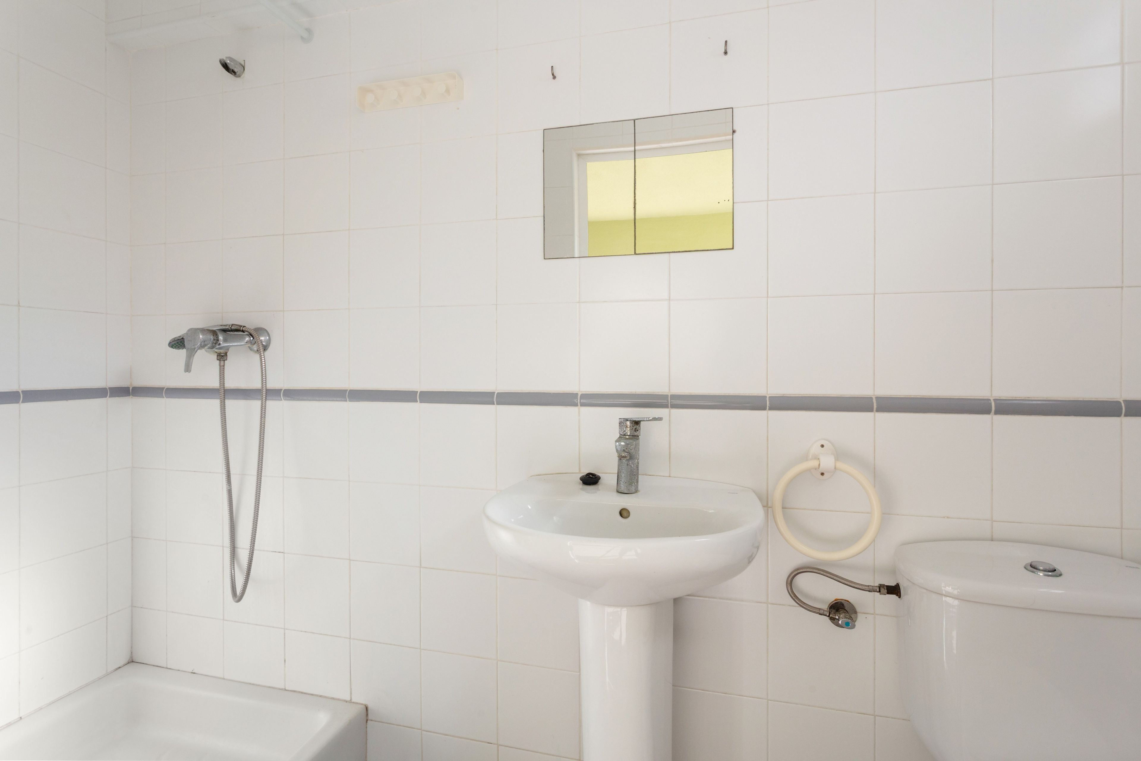 A bathroom with a bathtub, a sink, and a toilet.