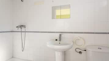 A bathroom with a bathtub, a sink, and a toilet.