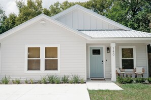 A single-story white house with a front porch, a door, and two windows. - Bright and Cozy St. Augustine Home near Downtown (St. Augustine)