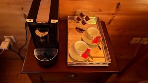 A wooden table with a coffee maker and a tray with cups and saucers. - Pink Room in a Wooden Chalet (Demi-Quartier)