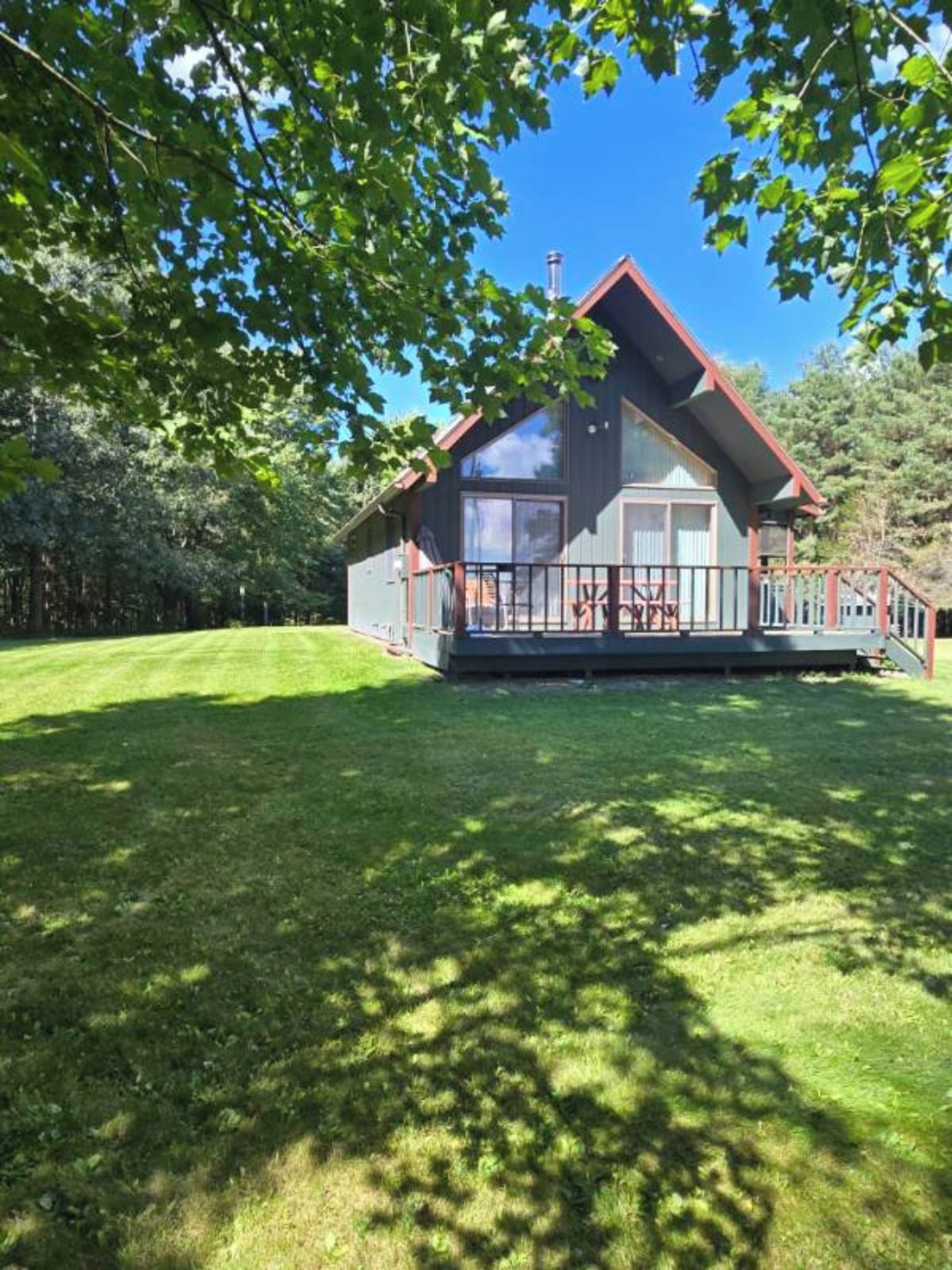 A two-story house with a porch and a fenced yard.