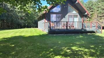 A two-story house with a porch and a fenced yard.