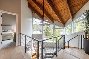 A modern interior with a wooden ceiling, large windows, and a staircase. - Designer Pinnacle Home with Free DV Shuttle (Park City)