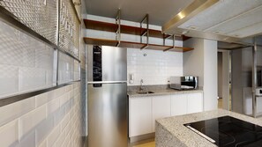 A modern kitchen with stainless steel appliances, white cabinetry, and a granite countertop. - VN Higienópolis, 450 meters from the Santa Cecília Metro Station (São Paulo)