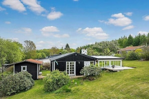 A residential property with a main house, a smaller shed, and a covered outdoor area. - Secluded cosy cottage on Söderåsen (Kvidinge)