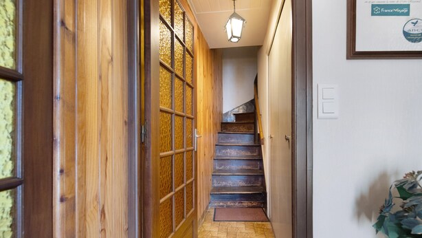 A wooden interior hallway with a tiled floor, a staircase, and a door with a window. - Guest Room "Chambre 1" with Wi-Fi (Courtils)