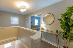 A staircase leading to a second floor with a view of a living room. - Modern 2BR Near Downtown Ipswich (Ipswich)
