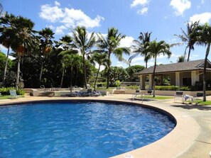 A swimming pool surrounded by palm trees and lounge chairs. - Wake Up to Golf Course Views & Resort Amenities (Kapolei)