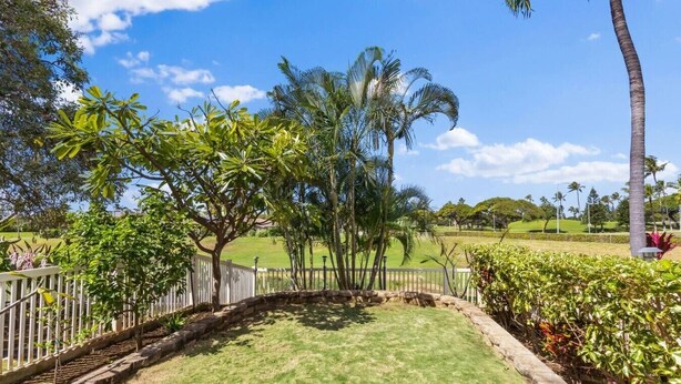 A well-maintained lawn with a white fence, palm trees, and a clear blue sky. - Wake Up to Golf Course Views & Resort Amenities (Kapolei)