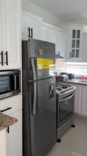 Coffee/tea maker, fridge, microwave, oven