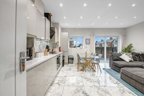 Una cocina moderna con comedor, sofá y vistas al exterior.