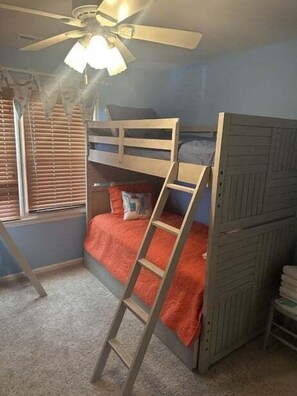 A bunk bed with a ladder, a ceiling fan, and a window with blinds. - Canal-front 3BR, 2BA retreat with dock, WiFi, grill, and dog-friendly comfort. (Supply)