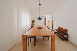 A dining area with a wooden table, chairs, and a bench.