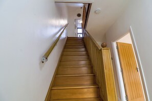 A wooden staircase with a handrail, leading to a door at the top. - Amazing 6 Bed House
Sleeps 14 | Private Parking | EV Charger | Long Stays (London)