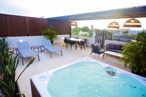 A rooftop terrace with a hot tub, lounge chairs, and outdoor seating. - Alluring New Apt w/ private Rooftop/Old city (Cartagena de Indias)