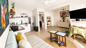 A modern apartment with a kitchen, dining area, and living room. - Cliffside Caribbean Condo: Beach & Ocean Views (Ocho Rios)