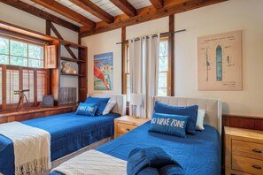 A room with two beds, a telescope, a poster, and a window with blinds. - Tranquil Manor - Lake Geneva English Tudor Estate (Lake Geneva)