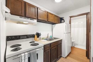 A compact kitchen with a stove, sink, and refrigerator. - UW Hospital Retreat with Dedicated Workspace (Madison)