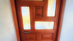 A wooden door with a geometric pattern and a handle.