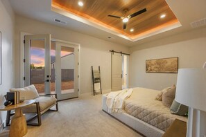 A bedroom with a bed, a chair, a table, and a ceiling fan. - Fully Furnished Modern Desert Retreat in Hurricane (Hurricane)
