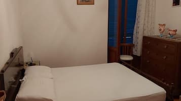 Tabla de planchar con plancha y ropa de cama